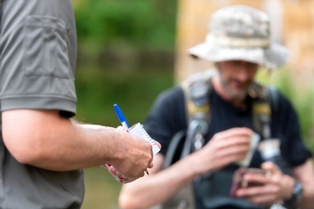 Police officer checking fisherman license